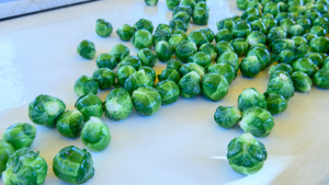 Brussel sprouts moving on a conveyer belt during processing.