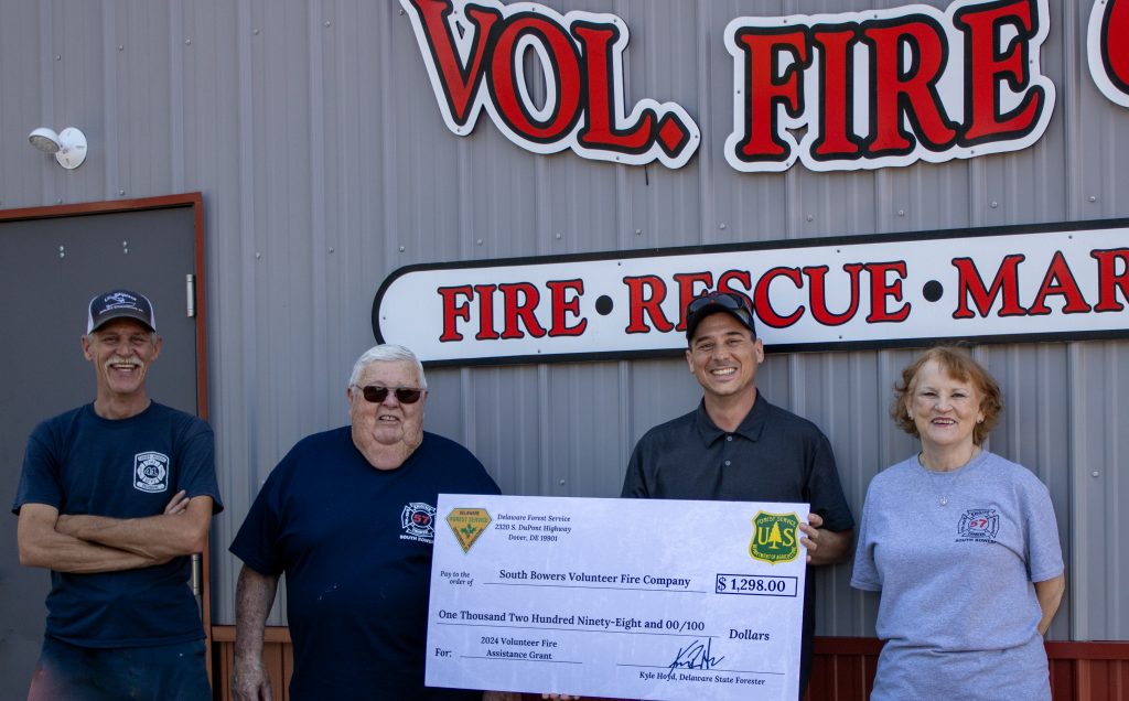 Members of the South Bowers Volunteer Fire Company and the Delaware Forest Service’s Sam Topper as South Bowers VFC receives a ceremonial check for $1298 in VFA grant funding for 2024.
